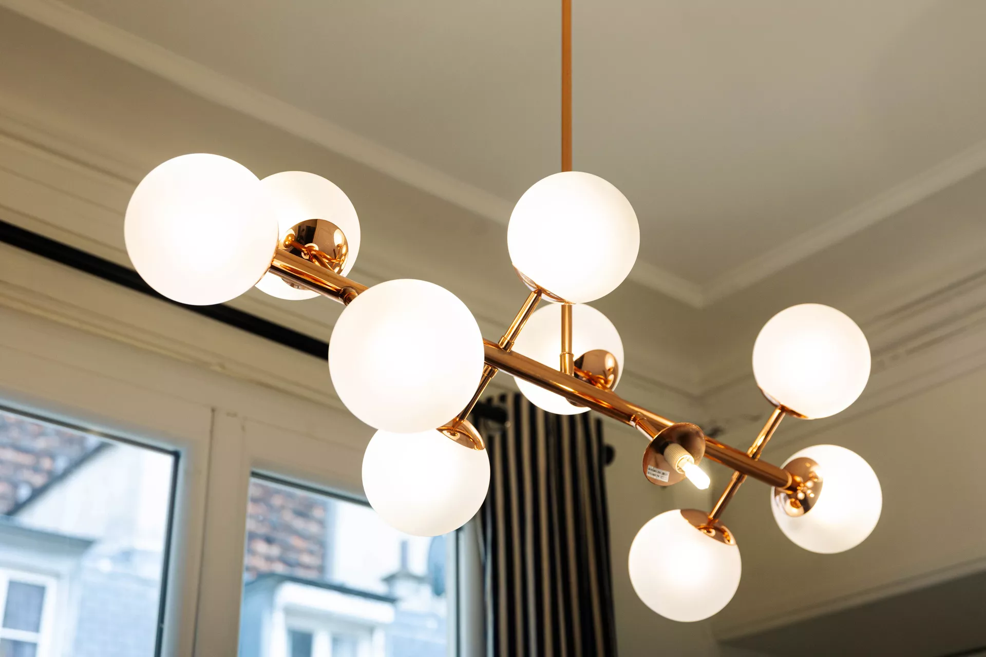Bien immobilier à vendre à Paris 8ème - détail lustre design doré globes blancs appartement haussmannien 75008